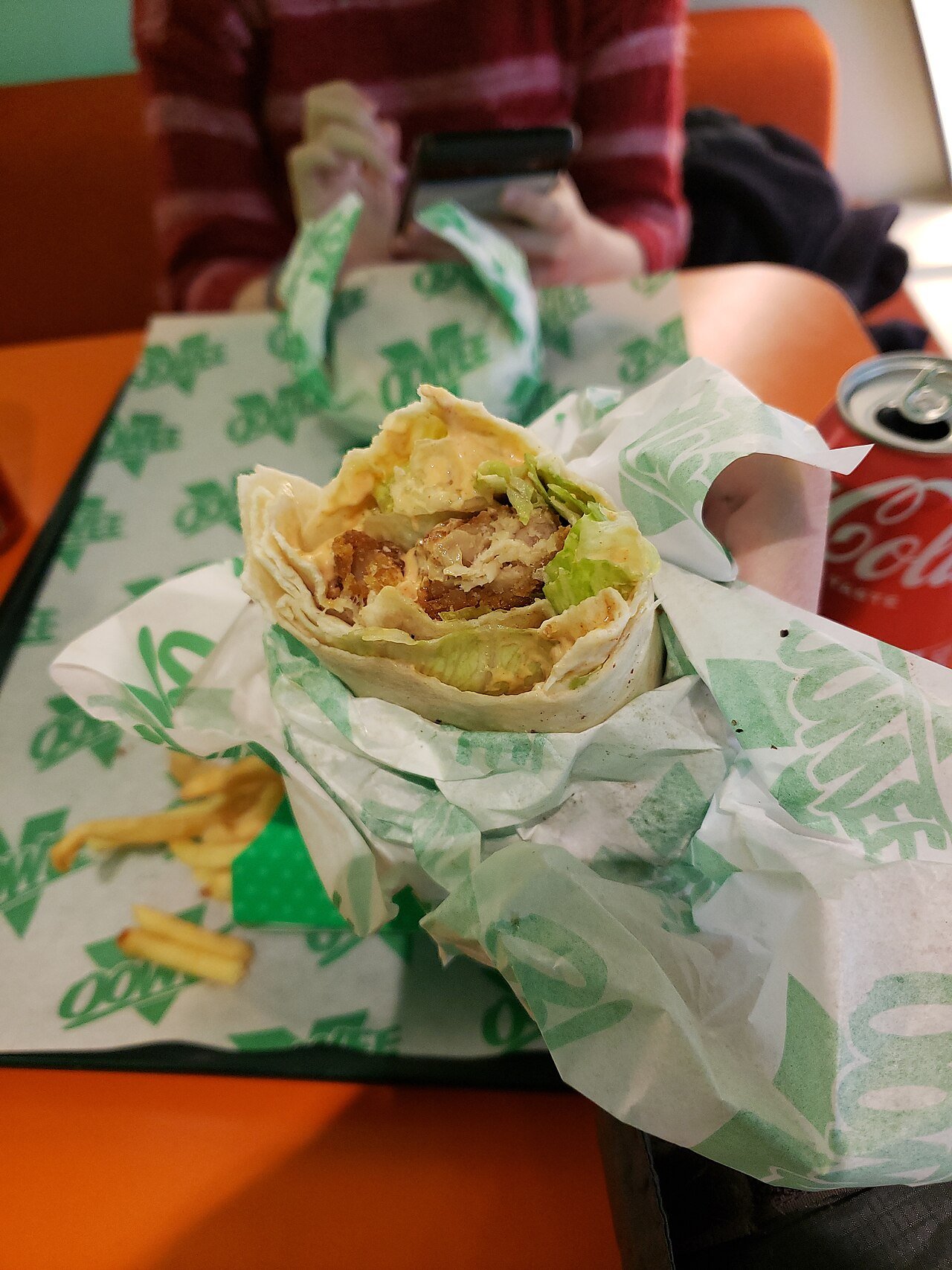 Chicken Caesar wrap cut in half showing filling.