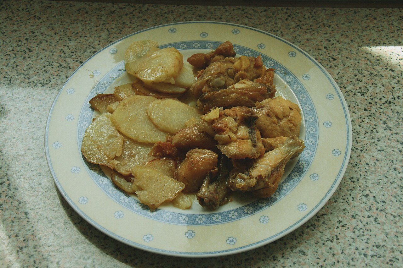 Golden garlic butter chicken bites in a skillet with herbs.