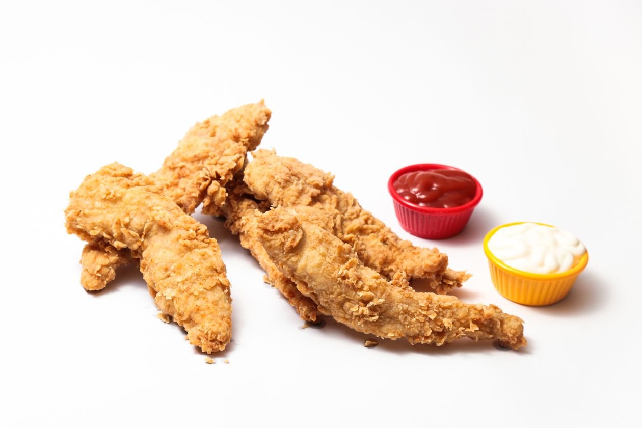 Golden crispy air fryer chicken tenders with dipping sauces.