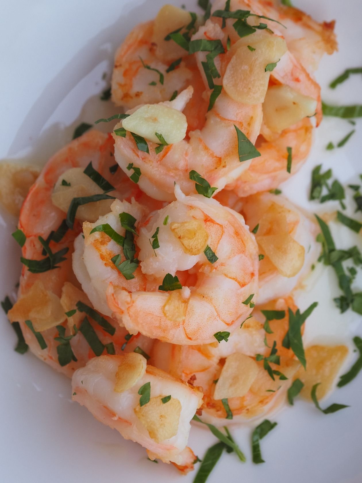 Buttery garlic shrimp with herbs, glistening and golden from the air fryer.