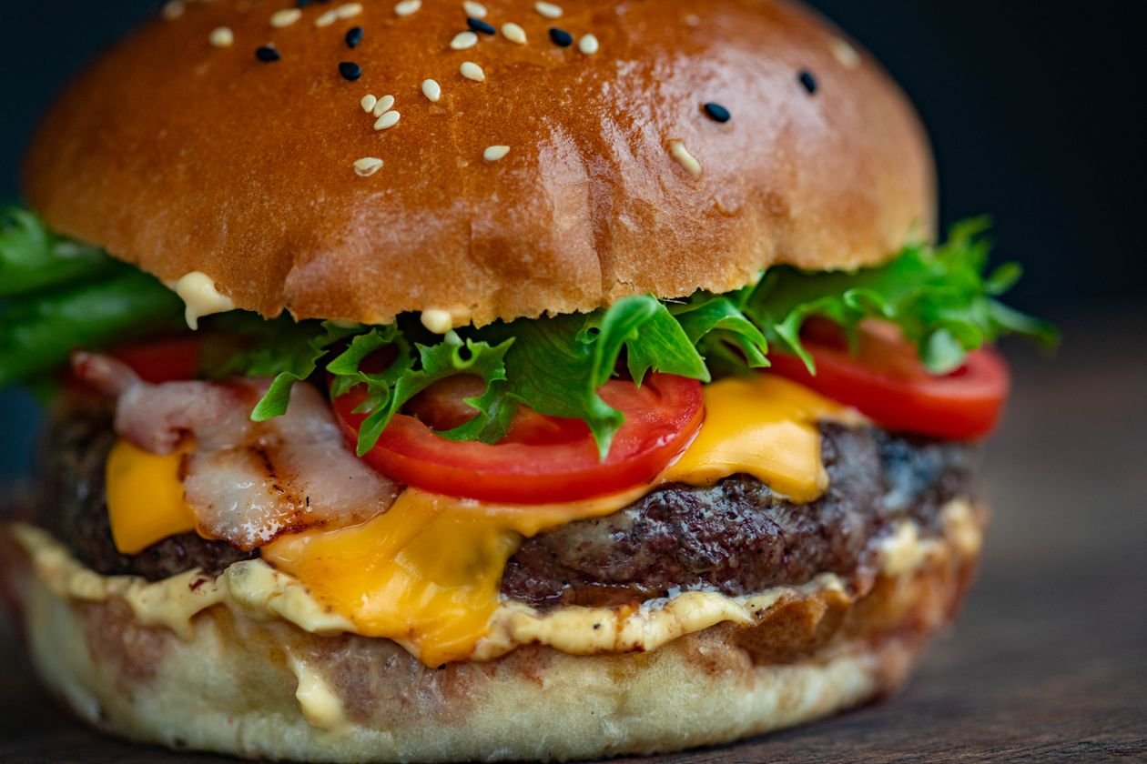 Juicy turkey burger with lettuce, tomato, and melted cheese on a bun.