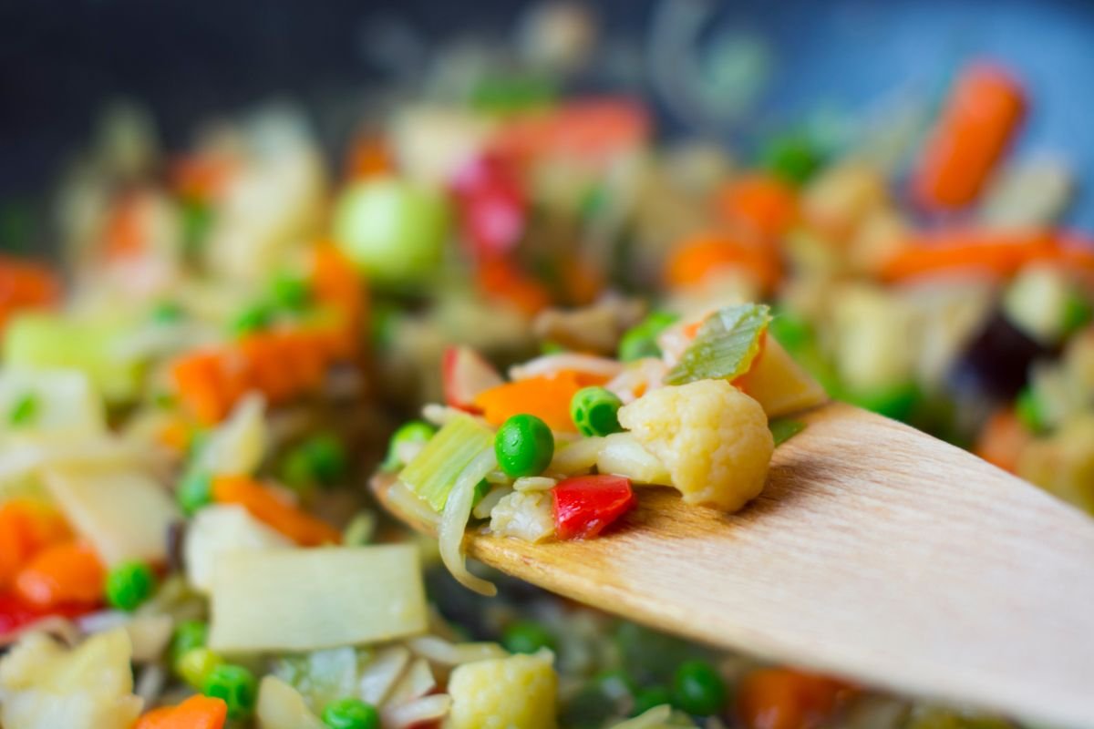 A skillet of egg roll in a bowl — savory cabbage, pork, and carrots with sesame.