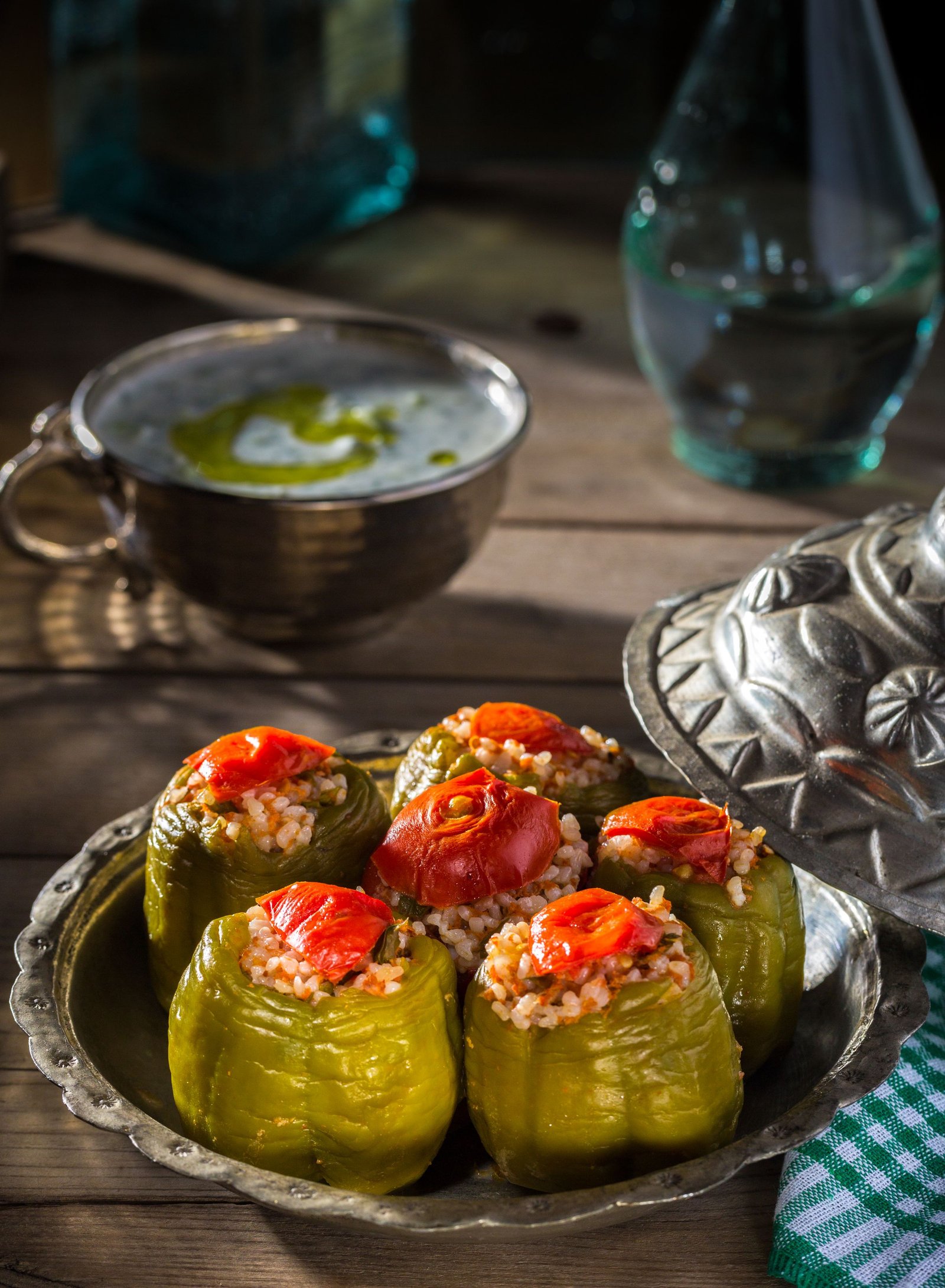 Colorful stuffed bell peppers with melted cheese tops in a baking dish.
