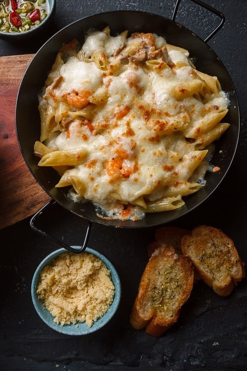 Baked stuffed pasta shells topped with melted cheese and marinara.