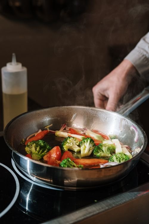 Beef and broccoli stir-fry in a pan coated with glossy sauce.
