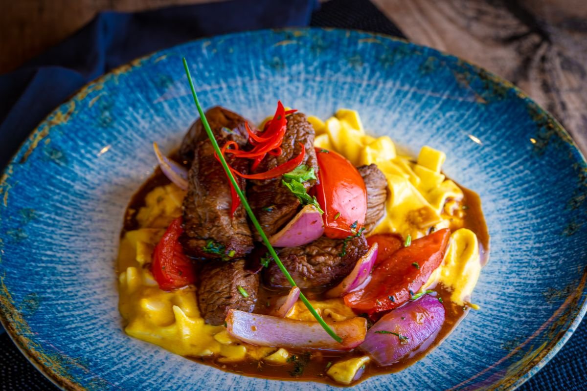 A bowl of creamy beef stroganoff with tender beef strips, mushrooms, and pasta.